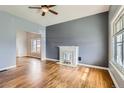 Spacious living room featuring hardwood floors, a decorative fireplace, and ample natural light at 339 Delaware St, Denver, CO 80223