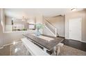 Charming dining area with neutral decor and an airy feel, complemented by a modern staircase at 25403 E 2Nd Ave, Aurora, CO 80018