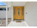 Elegant wooden front door with glass panels and decorative accents at 3293 S Florence Ct, Denver, CO 80231