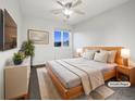 Comfortable bedroom with modern furnishings, a large window, and neutral decor creating a relaxing atmosphere at 6108 Kochia Ct # 104, Erie, CO 80516