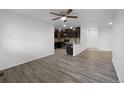 Spacious open living area featuring hardwood flooring, neutral paint, and ample natural light at 6108 Kochia Ct # 104, Erie, CO 80516