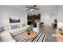 Bright living room and kitchen area with hardwood floors, modern furnishings, and open concept design at 6108 Kochia Ct # 104, Erie, CO 80516