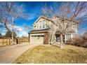 Beautiful home with a two-car garage and manicured lawn at 23201 E Orchard Pl, Aurora, CO 80015