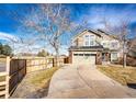Two-story home featuring an attached garage and driveway, complemented by a well-kept lawn at 23201 E Orchard Pl, Aurora, CO 80015