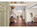 Elegant foyer featuring hardwood floors, a staircase, and views into the living spaces at 1448 E Maplewood Ct, Centennial, CO 80121
