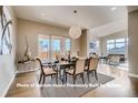 Elegant dining room featuring a modern chandelier and large windows at 1055 Greens Pl, Erie, CO 80516