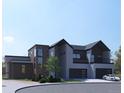 Contemporary home showcases clean lines, stone accents, a two-car garage, and modern design elements at 1055 Greens Pl, Erie, CO 80516