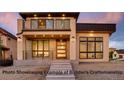 Craftsman style exterior with tan stucco, stone accents, dark trim, wood door, modern design, and concrete steps at 1055 Greens Pl, Erie, CO 80516