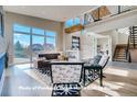 Bright living room with high ceilings, large windows, and a modern fireplace at 1055 Greens Pl, Erie, CO 80516