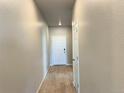 Inviting hallway featuring wood-like floors and white doors at 17170 E 90Th Pl, Commerce City, CO 80022
