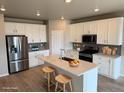 Bright kitchen with stainless steel appliances, a center island, and barstool seating at 17170 E 90Th Pl, Commerce City, CO 80022