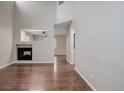 Spacious living room featuring a fireplace, neutral paint, attractive floors and an open layout at 15828 Greenstone Ln, Parker, CO 80134