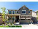 Charming two-story home with a stone-accented facade, covered porch, and well-maintained landscaping at 24326 E Ohio Dr, Aurora, CO 80018