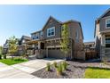 Beautiful two-story home featuring a stone facade, covered porch, and a well-manicured front yard at 24326 E Ohio Dr, Aurora, CO 80018