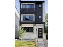 Contemporary home with a black and white exterior, showcasing clean lines, balconies, and inviting front entrance at 3435 W 17Th Ave, Denver, CO 80204