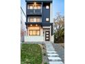 Contemporary three-story home features a modern design with a combination of brick, siding, and stylish balconies at 3435 W 17Th Ave, Denver, CO 80204