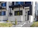 Modern home's entrance with clean lines, featuring a covered porch and well-maintained landscaping at 3435 W 17Th Ave, Denver, CO 80204