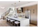 Bright, modern kitchen with island seating, stainless steel appliances, and stylish pendant lighting at 3435 W 17Th Ave, Denver, CO 80204