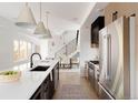 Stylish kitchen with a spacious island, modern appliances, and an adjacent dining area at 3435 W 17Th Ave, Denver, CO 80204