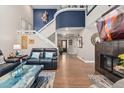 Spacious living room features a soaring ceiling, stylish furniture, a fireplace, and elegant decor at 9117 Nambe Trl, Lone Tree, CO 80124