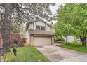Charming two-story home with a well-maintained lawn and a two-car garage in a mature neighborhood at 6443 S Florence Way, Englewood, CO 80111