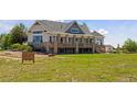 A gorgeous house with an outdoor wooden deck and a meticulously maintained lawn at 3048 Deer Creek Ranch Loop, Parker, CO 80138