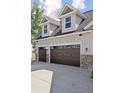 Attached garage with dual doors, matching brown trim, and dormer windows at 3048 Deer Creek Ranch Loop, Parker, CO 80138