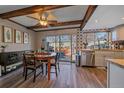 Updated kitchen with wood beams, stainless steel appliances, and stylish backsplash at 2293 S Oswego Way, Aurora, CO 80014