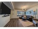 Living room features hardwood floors, L-shaped sofa and large TV at 2293 S Oswego Way, Aurora, CO 80014