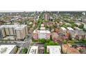 The aerial view showcases the apartment building in a vibrant neighborhood with a mix of residential and commercial buildings at 1196 N Grant St # 705, Denver, CO 80203
