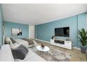 Cozy living area with hardwood floors, modern TV setup, and stylish furnishings at 1196 N Grant St # 705, Denver, CO 80203