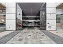 Modern building entrance shows a path to the mirrored entryway of the building at 891 14Th St # 2703, Denver, CO 80202