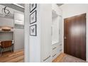 Entryway with closet and white built-ins adjacent to a wooden door and light hardwood flooring at 891 14Th St # 2703, Denver, CO 80202