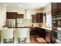 Stylish kitchen featuring a breakfast bar, stainless steel appliances, and ample cabinet space at 6840 Northstar Cir, Castle Rock, CO 80108