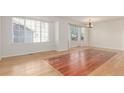 Dining room with hardwood floors and large windows, offering natural light at 4460 S Himalaya Ct, Aurora, CO 80015