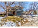 Two-story house with gray siding, double garage, and landscaping at 4460 S Himalaya Ct, Aurora, CO 80015