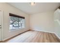 Bright living room with a large window and hardwood floors, next to the stairway at 3033 W 107Th Pl # D, Westminster, CO 80031