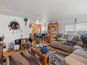 Living room with comfortable seating, fireplace, and large TV at 635 2Nd St, Bennett, CO 80102