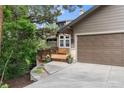 Charming home with a two-car garage, a wooden deck, and a beautifully landscaped front yard at 1122 Forest Trails Dr, Castle Pines, CO 80108