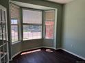Bright sitting area showcasing a charming bay window with views of the neighborhood and sleek wood floors at 1251 N Burlington Dr, Castle Rock, CO 80104