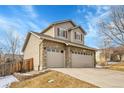 Beautiful two-story home with stone accents and a three-car garage, complemented by a well-maintained yard at 13953 Forest St, Thornton, CO 80602