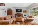 Cozy living room showcasing hardwood floors, comfortable seating, and natural light at 11826 W Stanford Pl, Morrison, CO 80465