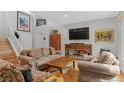 Comfortable living area boasting hardwood floors, a large TV, and stylish decor at 11826 W Stanford Pl, Morrison, CO 80465