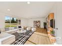 Bright living room with hardwood floors, a large window, modern decor, and ample natural light at 12682 Anhawa Ave, Longmont, CO 80503