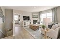 Bright living room boasts a fireplace, large window, and views into an adjacent bedroom at 16113 Alpine Sorrel Dr, Monument, CO 80132