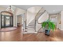 Grand foyer featuring a curved staircase, hardwood floors, and a stylish entryway with natural light at 237 Lead King Dr, Castle Rock, CO 80108
