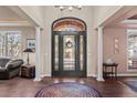 Elegant foyer with hardwood floors, arched doorway, decorative rug, and sophisticated accents at 237 Lead King Dr, Castle Rock, CO 80108