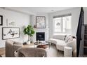 Open living room featuring a white couch and corner fireplace at 2820 W 26Th Ave # 101, Denver, CO 80211