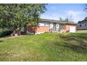 Charming single-story home with a well-manicured lawn, mature trees, and beautiful landscaping at 3061 S Mabry Ct, Denver, CO 80236