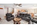 Spacious living room with a ceiling fan, plush seating, and open access to the kitchen area at 6210 Wescroft Ave, Castle Rock, CO 80104